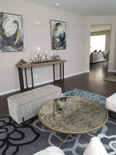 A bright, clean living room with white sofa and soft natural light, professionally cleaned by Wonderful Laura Cleaning