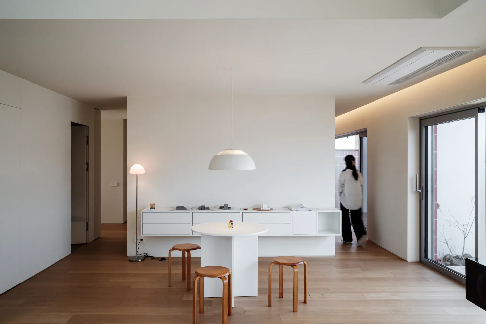 A calm, soft living room with white furniture and warm natural light, professionally cleaned